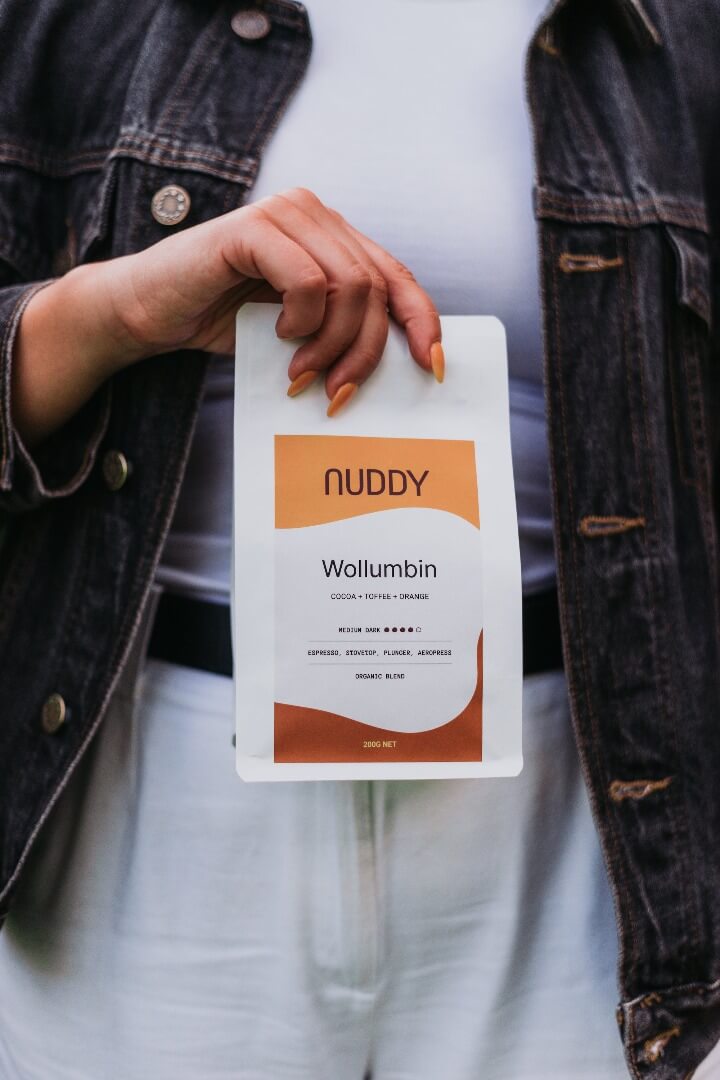 Holding bag of Nuddy Coffee Organic Blend Wollumbin